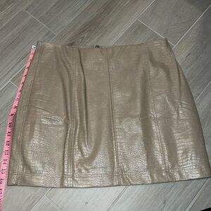 Tan mini skirt. Never worn, size large. No tags.
